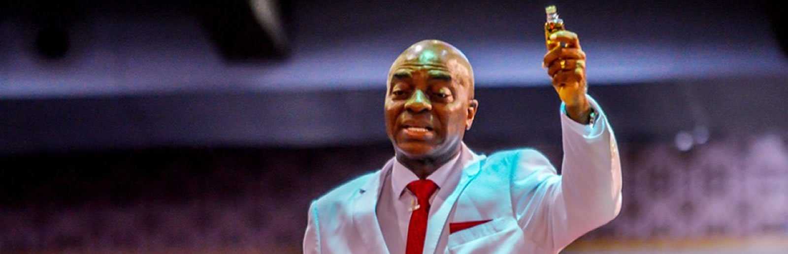 Bishop David Oyedepo Holding a bottle of anointing oil